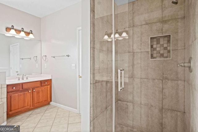 bathroom with tile patterned flooring, a shower with door, and vanity