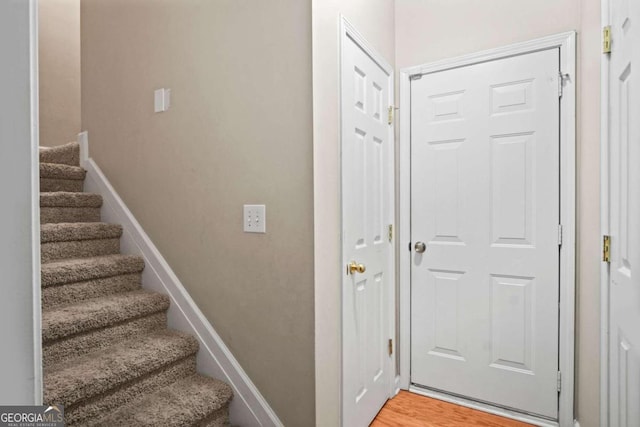 stairway featuring hardwood / wood-style flooring