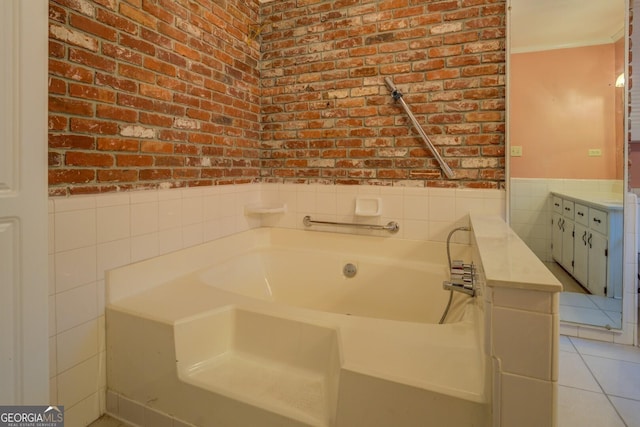 bathroom featuring tile patterned flooring, vanity, a tub to relax in, and tile walls