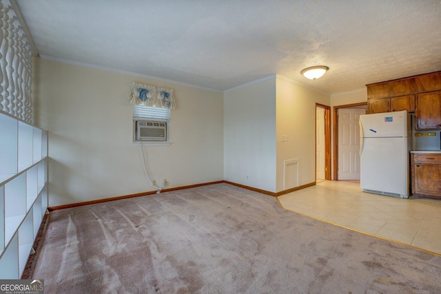 carpeted empty room featuring cooling unit, crown molding, and a textured ceiling