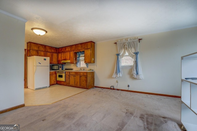 kitchen featuring built in microwave, stainless steel gas range, white fridge, a textured ceiling, and light carpet