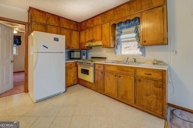 kitchen with ceiling fan, sink, white appliances, and ornamental molding