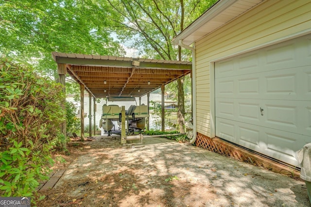 view of patio / terrace featuring a carport and a water view