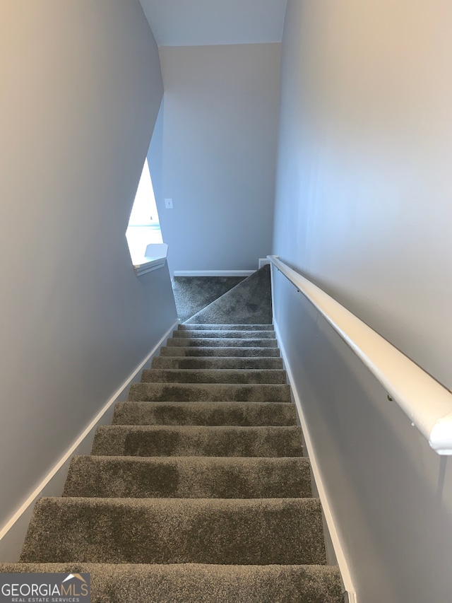 stairs featuring carpet