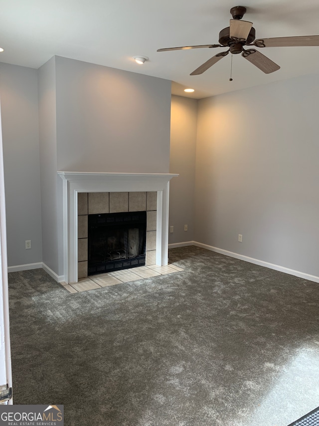 unfurnished living room with carpet, a fireplace, and ceiling fan