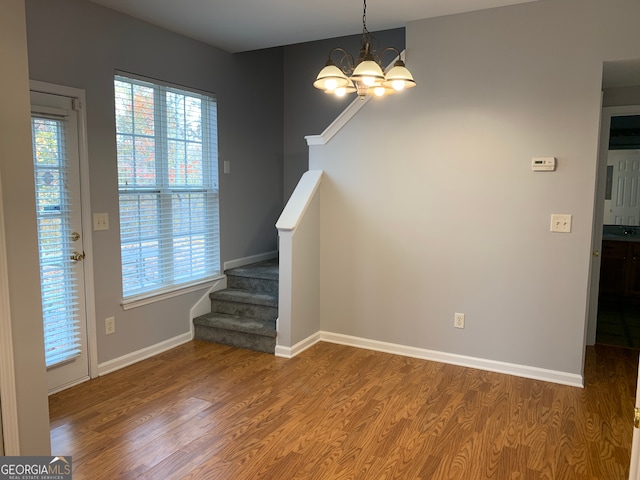 interior space featuring an inviting chandelier and hardwood / wood-style flooring