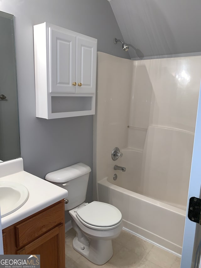 full bathroom with vaulted ceiling, vanity, tile patterned flooring, shower / tub combination, and toilet