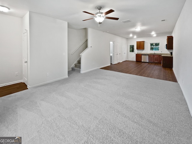 unfurnished living room with ceiling fan and dark hardwood / wood-style flooring