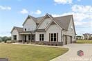 view of front of house featuring a garage and a front lawn