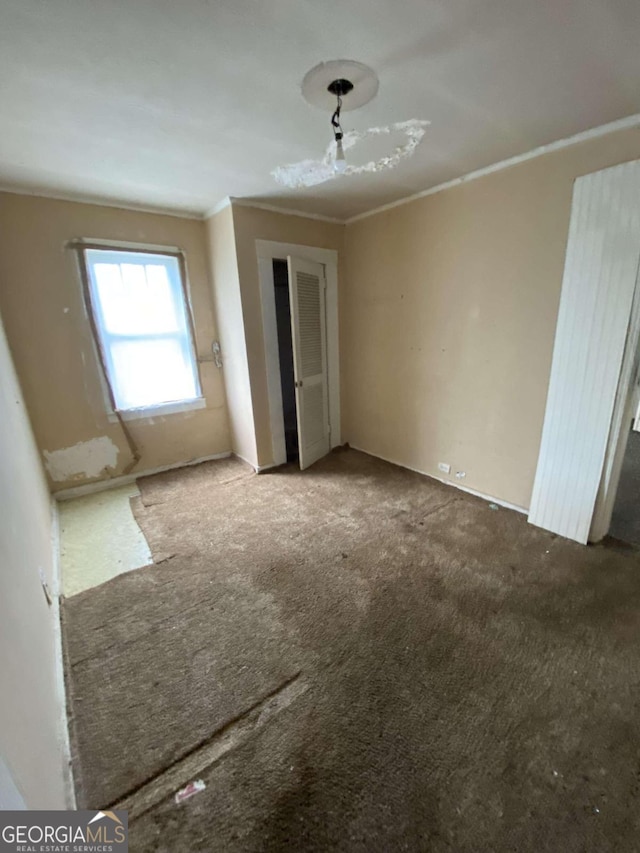 unfurnished bedroom with carpet floors and ornamental molding