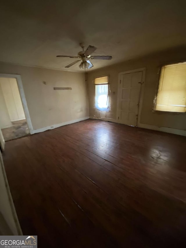 interior space featuring ceiling fan and dark hardwood / wood-style flooring