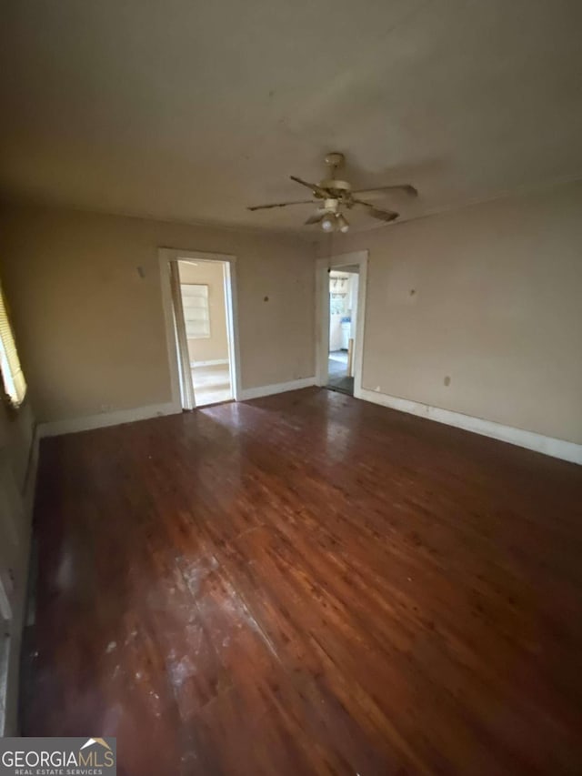 unfurnished room featuring dark hardwood / wood-style flooring and ceiling fan