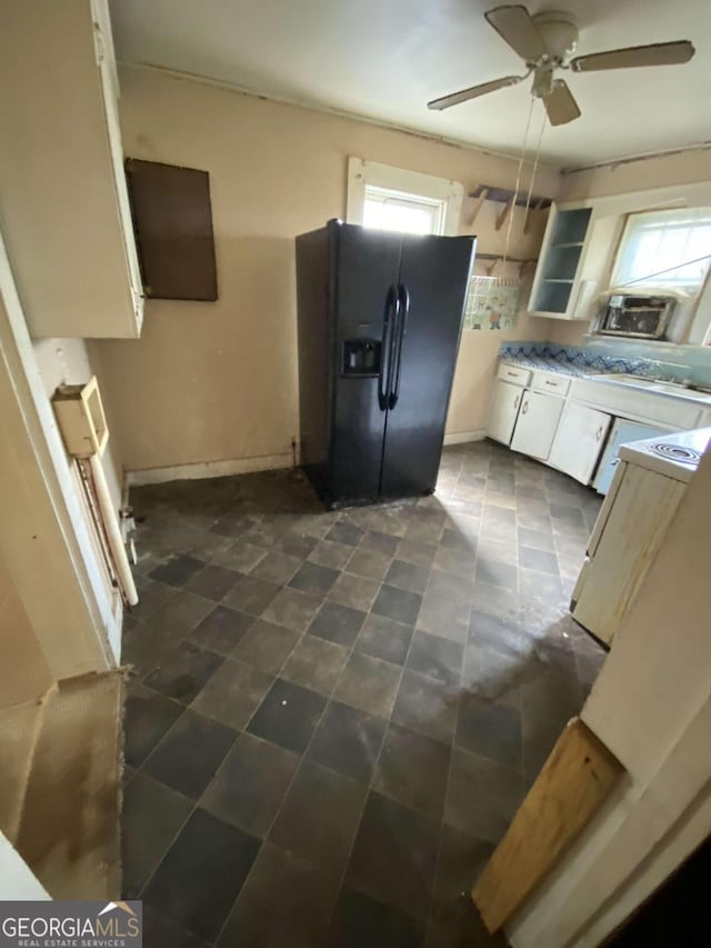 kitchen featuring white cabinetry, ceiling fan, and black refrigerator with ice dispenser