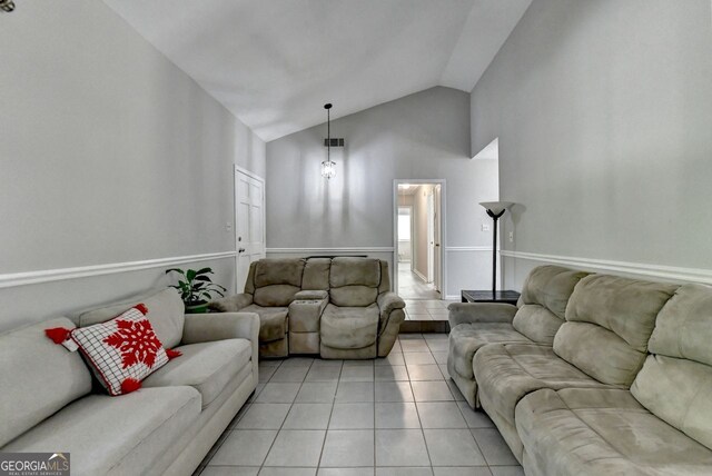 living room with light tile patterned floors and lofted ceiling