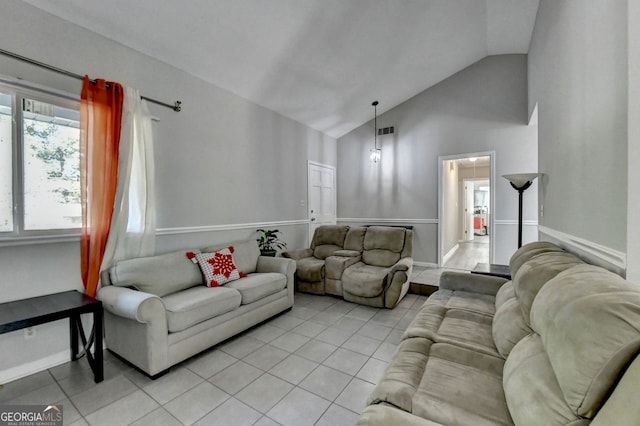 tiled living room featuring vaulted ceiling