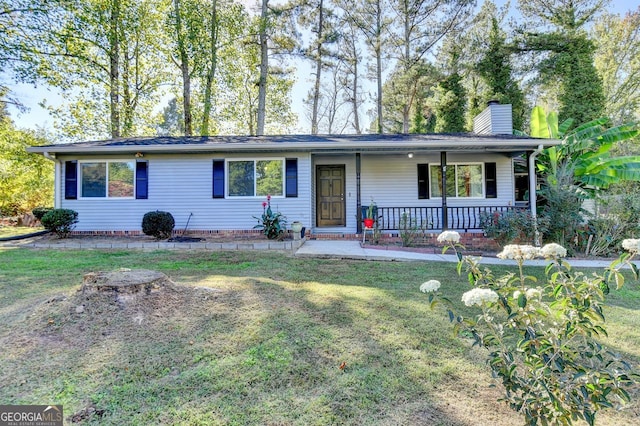 ranch-style home with a front lawn and covered porch