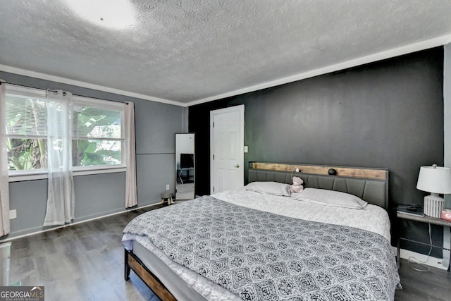 bedroom with dark wood-type flooring, crown molding, and a textured ceiling