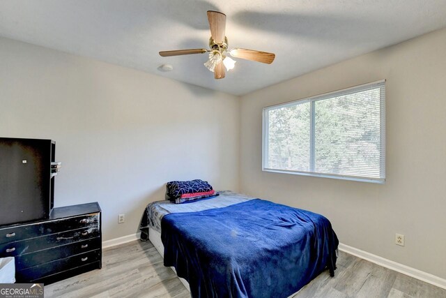 bedroom with light wood-type flooring and ceiling fan