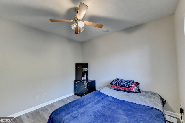 bedroom with light wood-type flooring and ceiling fan