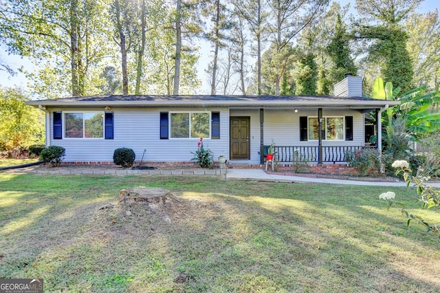 ranch-style home with a front yard and covered porch