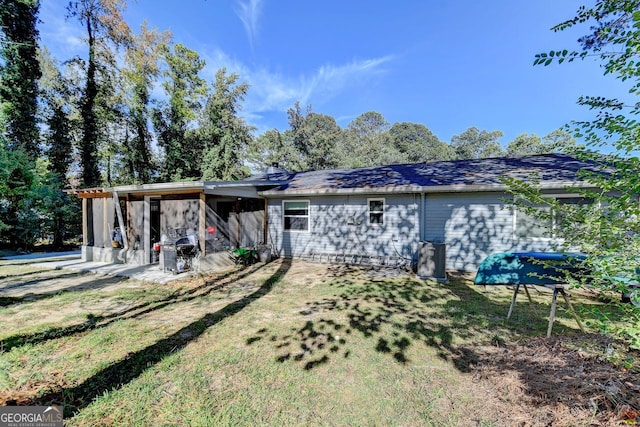 back of house with a patio and a yard