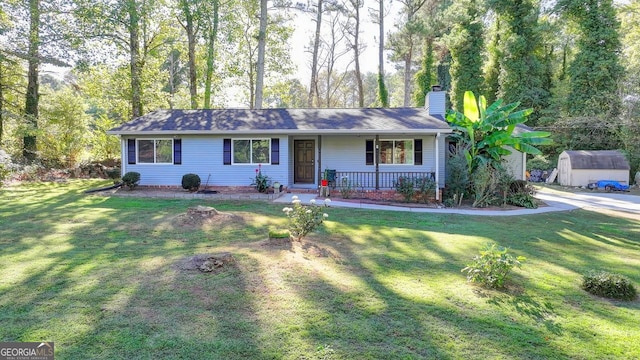 single story home featuring a storage shed, a front lawn, and a porch