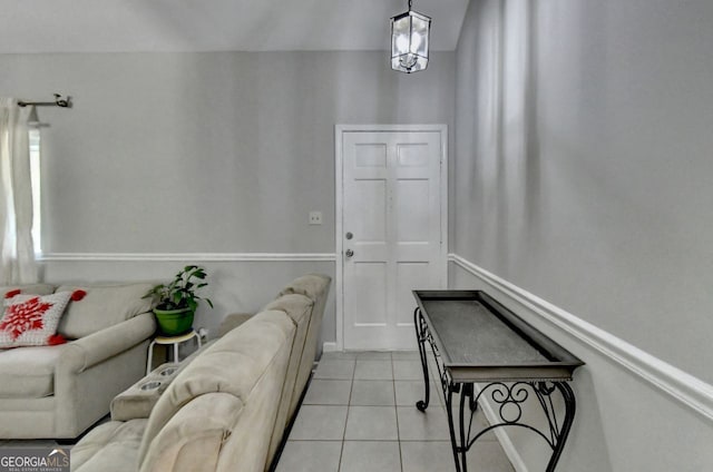 tiled living room featuring an inviting chandelier