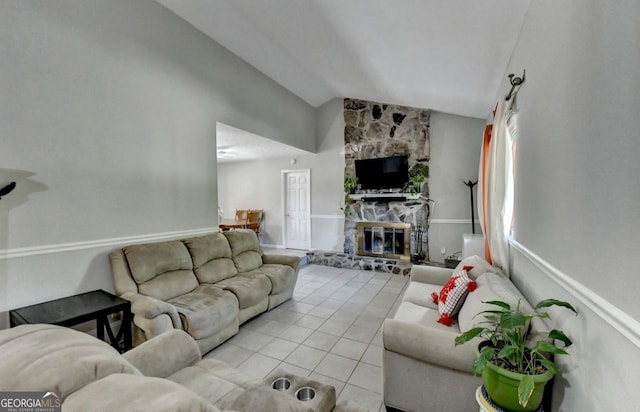 tiled living room with vaulted ceiling and a fireplace