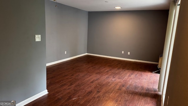 empty room with dark wood-type flooring