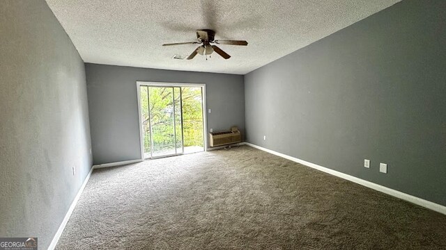 unfurnished room featuring ceiling fan, a textured ceiling, and carpet