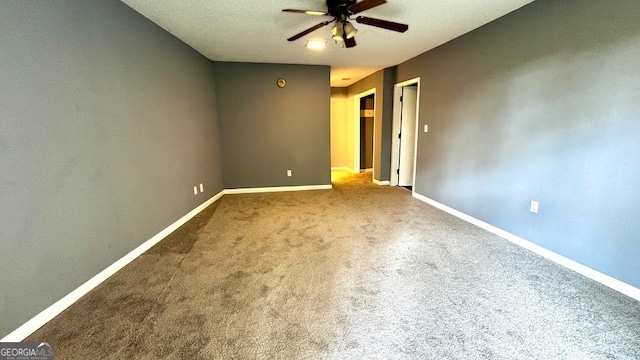 spare room featuring a textured ceiling, carpet, and ceiling fan