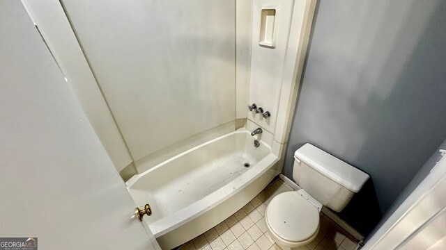 bathroom featuring tile patterned flooring, shower / bathtub combination, and toilet