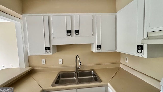 kitchen with white cabinetry and sink