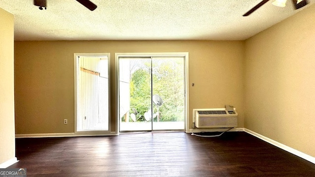 entryway featuring a textured ceiling, dark hardwood / wood-style floors, and ceiling fan