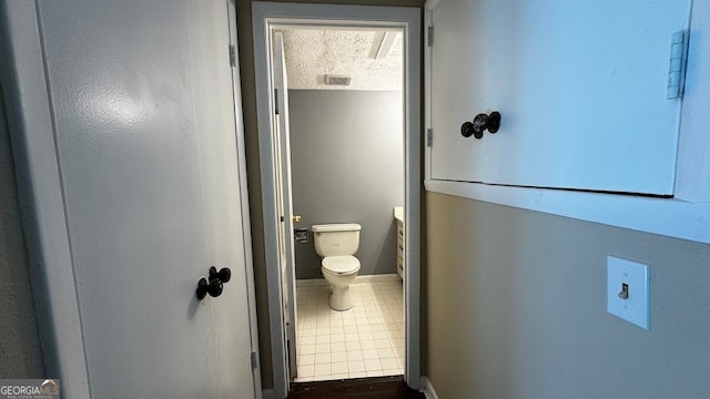 bathroom with toilet and tile patterned floors