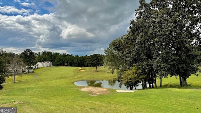 view of property's community with a yard and a water view