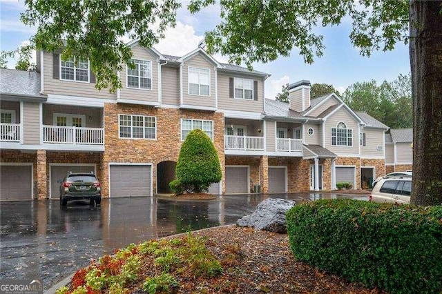 multi unit property featuring a balcony and a garage