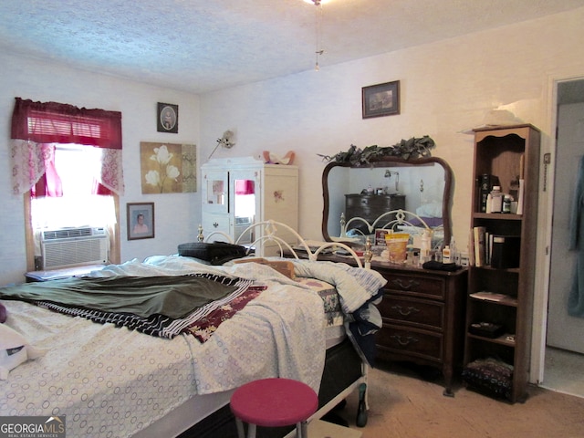 carpeted bedroom featuring cooling unit and a textured ceiling