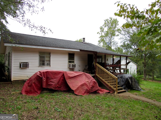 back of house with a lawn, cooling unit, and a wooden deck