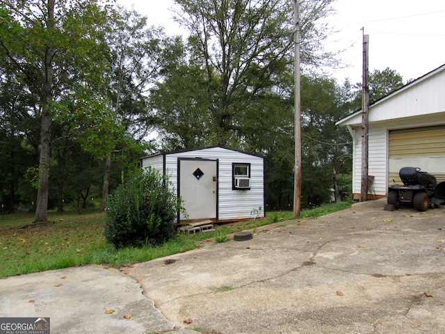 exterior space with cooling unit and a garage