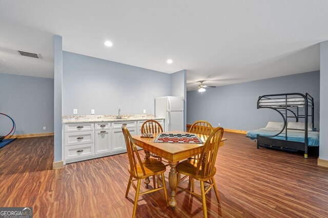 dining area featuring ceiling fan, dark hardwood / wood-style floors, and sink