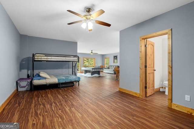 bedroom with ensuite bath, ceiling fan, and hardwood / wood-style flooring