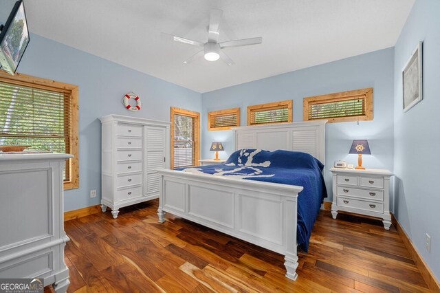 bedroom with ceiling fan and dark wood-type flooring