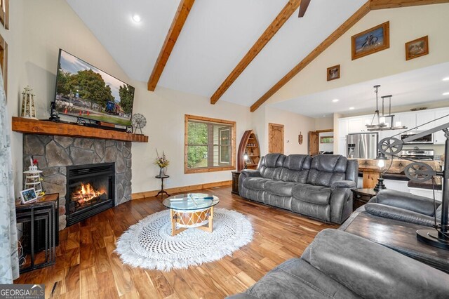 292 Silver Fox Trl, Blue Ridge, GA 30513 - living room featuring a stone fireplace, wood finished floors, beam ceiling, high vaulted ceiling, and recessed lighting
