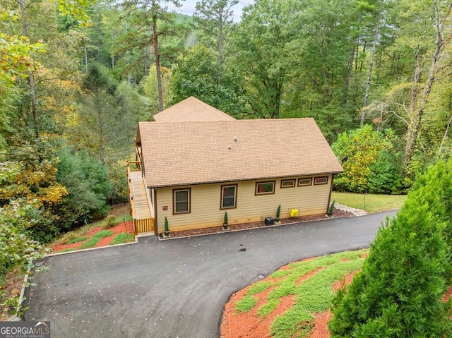 292 Silver Fox Trl, Blue Ridge, GA 30513 - view of front facade featuring stairway, roof with shingles, and a forest view
