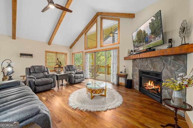 292 Silver Fox Trl, Blue Ridge, GA 30513 - living area with ceiling fan, a stone fireplace, high vaulted ceiling, beam ceiling, and wood finished floors