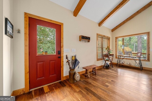 foyer entrance with lofted ceiling with beams, hardwood / wood-style flooring, and a healthy amount of sunlight