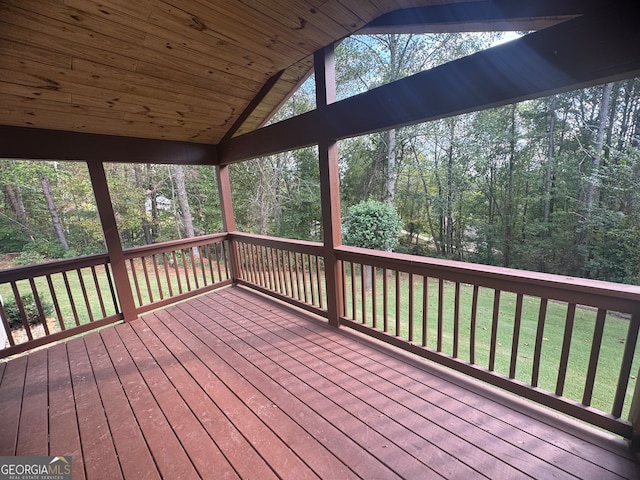 wooden terrace featuring a lawn