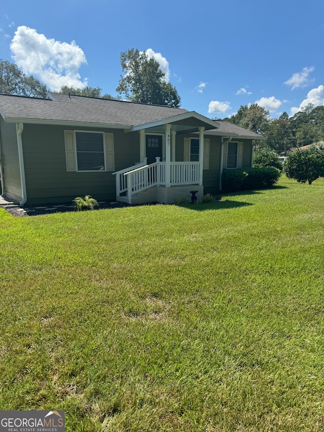 ranch-style home with a front lawn and a porch