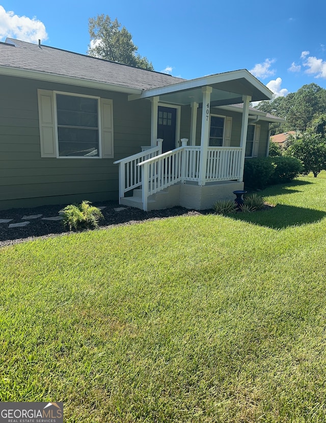 ranch-style home with a front yard and a porch